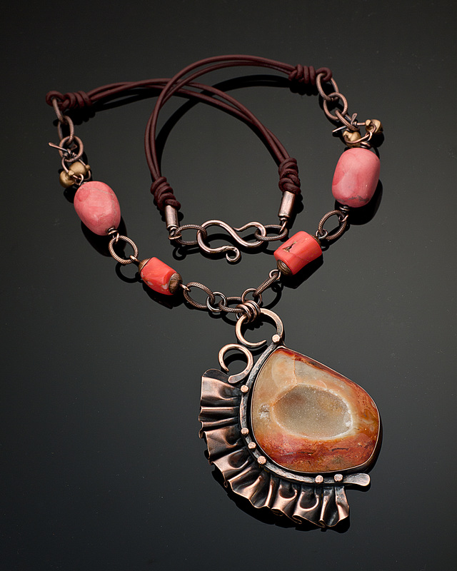 Kharisma Sommers, Quincy, IL, U.S., “Frilly Peach” (8.9 cm H focal) (3.5 in) Copper, drusy agate, marble and coral beads, bronze bells, leather -- www.foldforming.org