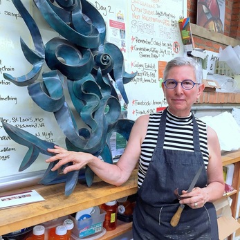 Linda Leviton, Lewis Center, OH, U.S., stands with her sculpture made with 