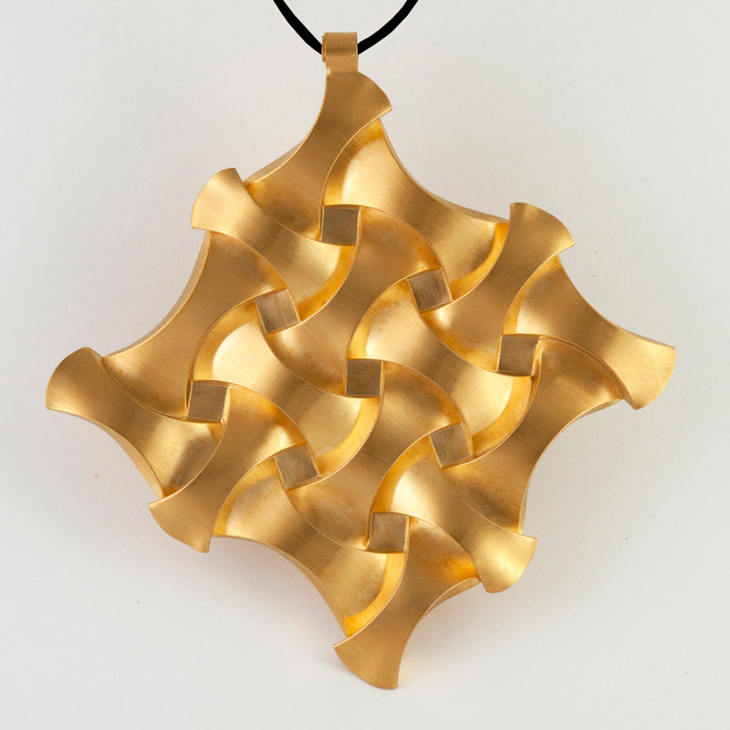  1st place 2021: Ilan Garibi, Binyamina, Israel “Rounded Cubes Pendant” (8 x 8 cm) (3.1 x 3.1 in) Gold plated brass - www.foldforming.org
