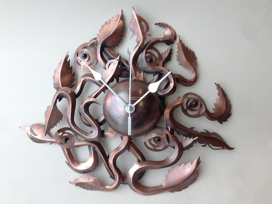 Leanne McCormack, Glengormley, Newtownabbey, Northern Ireland, U.K. “Climbing Roses Clock” (27 cm overall) Copper, clock parts, garnet www.foldforming.orgPicture